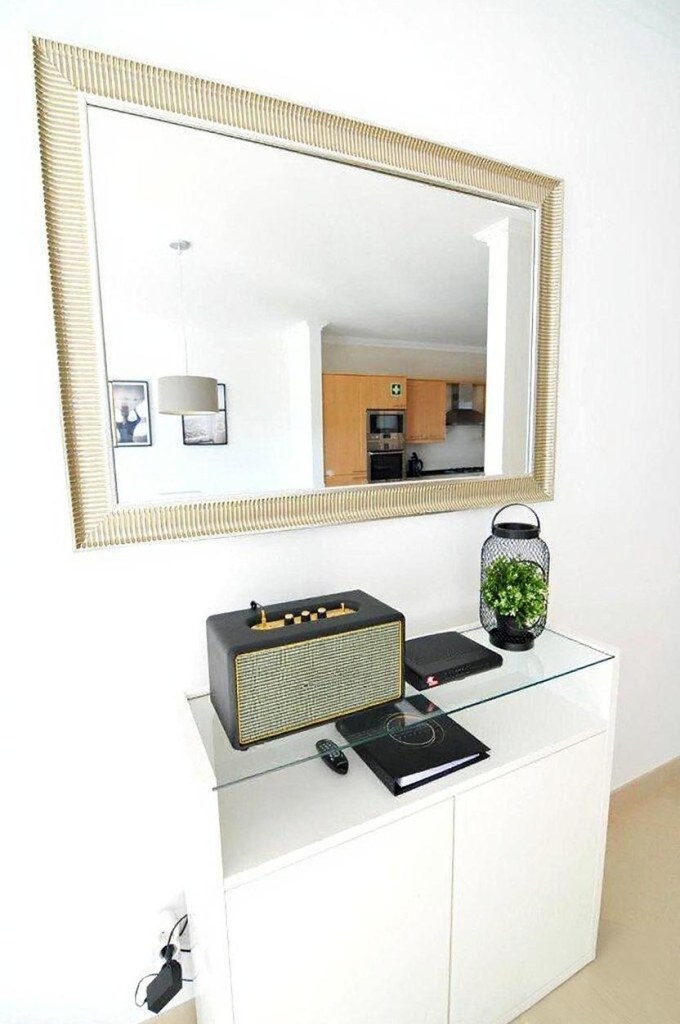Living room detail: speaker and large mirror