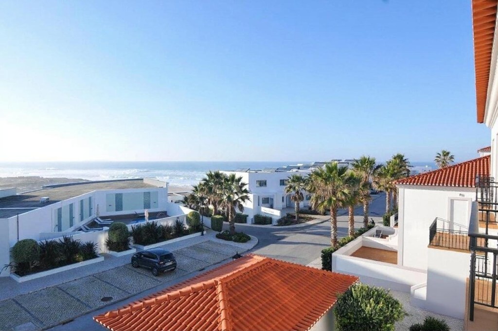 Panoramic view over the Atlantic, the resort villas and palm trees